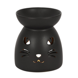 A matt black oil burner with a cut out cat face design