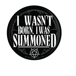 Black badge with white writing saying I Wasn't Born, I Was Summoned