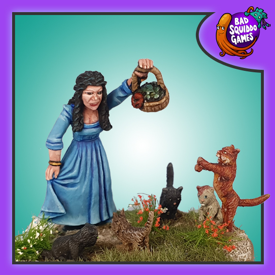 Bad Squiddo Games metal gaming figure, aria hold a basket of fish up high while her 5 kittens gather around her feet.