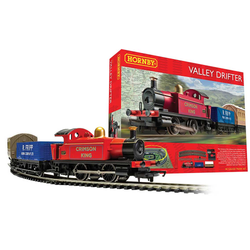 Valley Drifter Train Set by Hornby. A red train pulling a blue wagon and a brown carriage  in front of the red box depicting the same scene but going the opposite way 