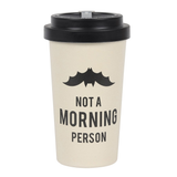 travel mug in a cream colour with an upside down bat and the words 'Not a morning person' written in black, topped with a black lid.