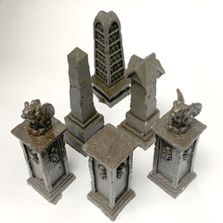Graveyard Pillar Set by Legend Games is a set of six pillars which combines some of the other pillar sets from the range together in one set. Two pillars are topped with a grotesque in the classic winged demon style one having a broken wing and one pillar is adorned with skulls
