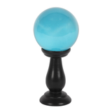 A beautiful teal crystal ball and stand