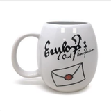 A great egg shaped white mug featuring the words Eeylops Owl Emporium and an envelope 