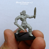Blood Dancers by Spellcrow is a pack of 2 resin miniatures and 2 bases (25mmx25mm) depicting a male fighter holding a sword in each hand, this image shows the miniature being held between someones fingers