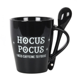 A lovely mug and spoon set in black, the mug has white writing saying Hocus Pocus I need caffeine to focus and the spoon has a crescent moon and stars motif.