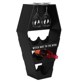 coffin shaped wine shelf is black with the words Witch Way To The Wine in white