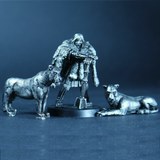 Ziva the Barbarian by Bad Squiddo Games is a metal miniature depicting a female barbarian resting on her weapon with her fur cape keeping her warm and her loyal pet big cats by her side