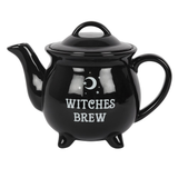 black teapot has white writing 'Witches Brew' and a white crescent moon