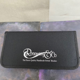 A Rosemary & Co brush case. This black case has the Rosemary & Co logo in white on the front