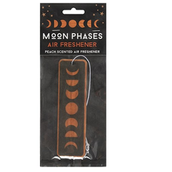A hanging peach scented air freshener in a long rectangle shape featuring the moon phases 