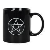 A ceramic black mug with a white design depicting the Wiccan pentagram five pointed star 