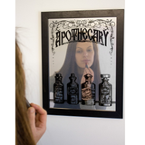 Framed Apothecary Mirrored Tin Sign with the reflection of a lady putting on her lipstick  
