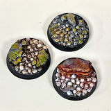 A pack of five resin 25mm bases adorned with skulls