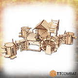 A wonderful MDF kit from TT Combat Savage Domain range of fantasy scenery enabling you to construct a water mill in a steam punk style with various heights and covers- full view with miniature 