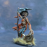 Gauntfield by Reaper Miniatures from their Bones range pre painted by Mrs MLG.  A bones miniature of a skeleton scarecrow holding a scythe in one hand and a bag of bones in the other, pre painted with orange and blue colours.