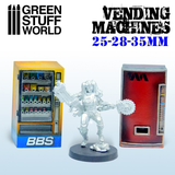 A set of two resin vending machines by Green Stuff World with a miniature for scale