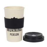 travel mug in a cream colour with an upside down bat and the words 'Not a morning person' written in black, topped with a black lid that is at the side of the mug
