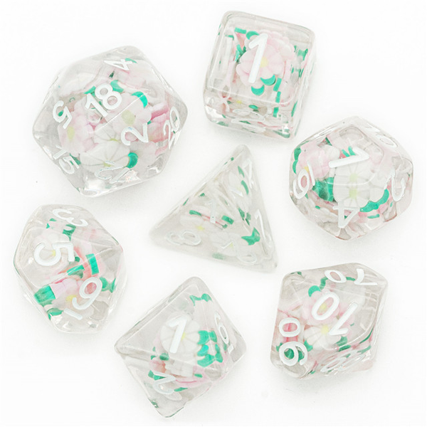 RPD  unusual dice are clear with white numbers and contain little white daisy shapes with green leaves