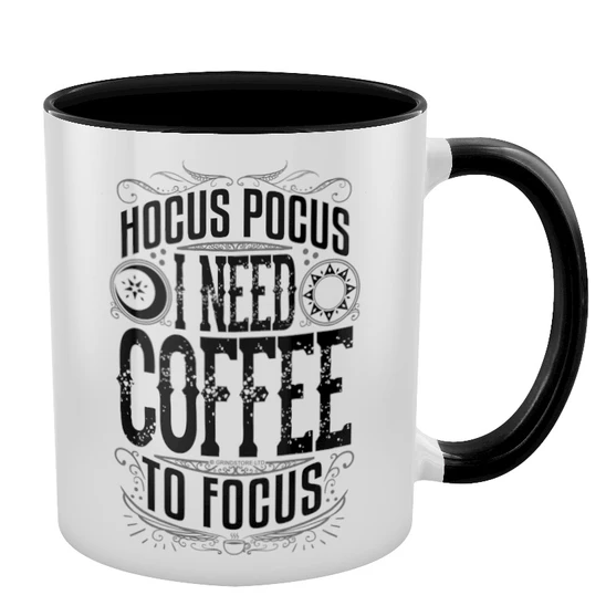 white mug featuring the words Hocus Pocus I Need Coffee To Focus in black, with black inner and black handle. 