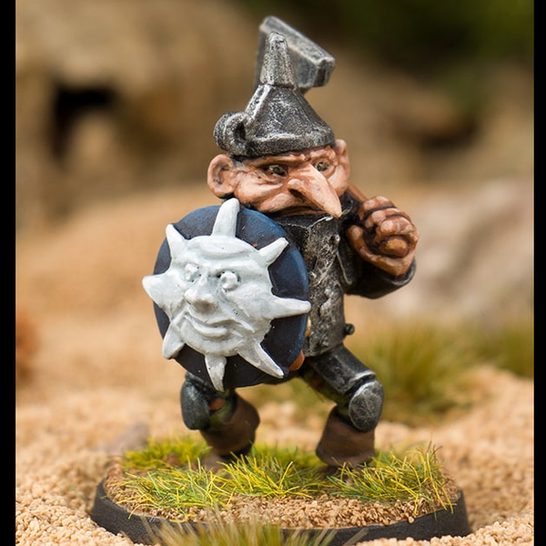 Sargent Chopper by Northumbrian Tin Solider is an old school style metal miniature for your gaming table holding an axe over his shoulder and a round shield in his other hand.