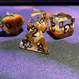 Skull Bird Head poly RPG dice.  These unusual dice have black numbers and contain a white bird skull shape upon a bed of gold shimmer