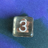 Entombed Teddy Dog Poly Dice Set. These unusual dice have silver numbers and contain a sweet brown dog sporting a bowtie and wide eyes 